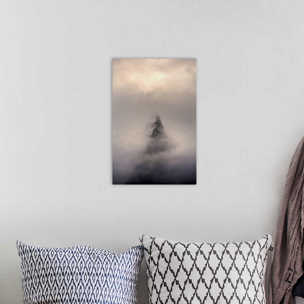 A bohemian room featuring Mountain top, Aiguille des Dru, in the fog in the valley of Chamonix in French Alpes.