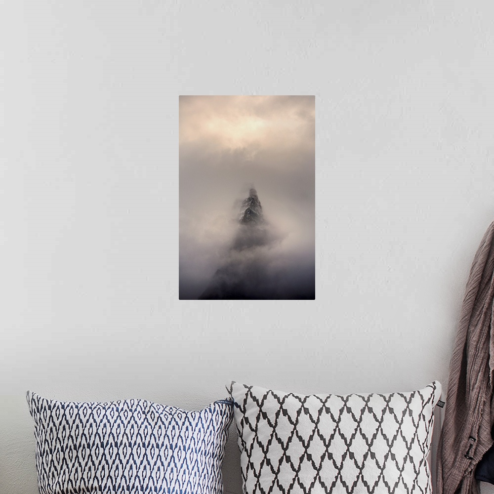 A bohemian room featuring Mountain top, Aiguille des Dru, in the fog in the valley of Chamonix in French Alpes.