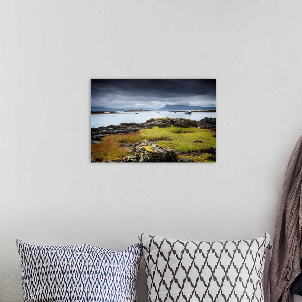 A bohemian room featuring Fine art photo of a rocky coast under a dark stormy sky.