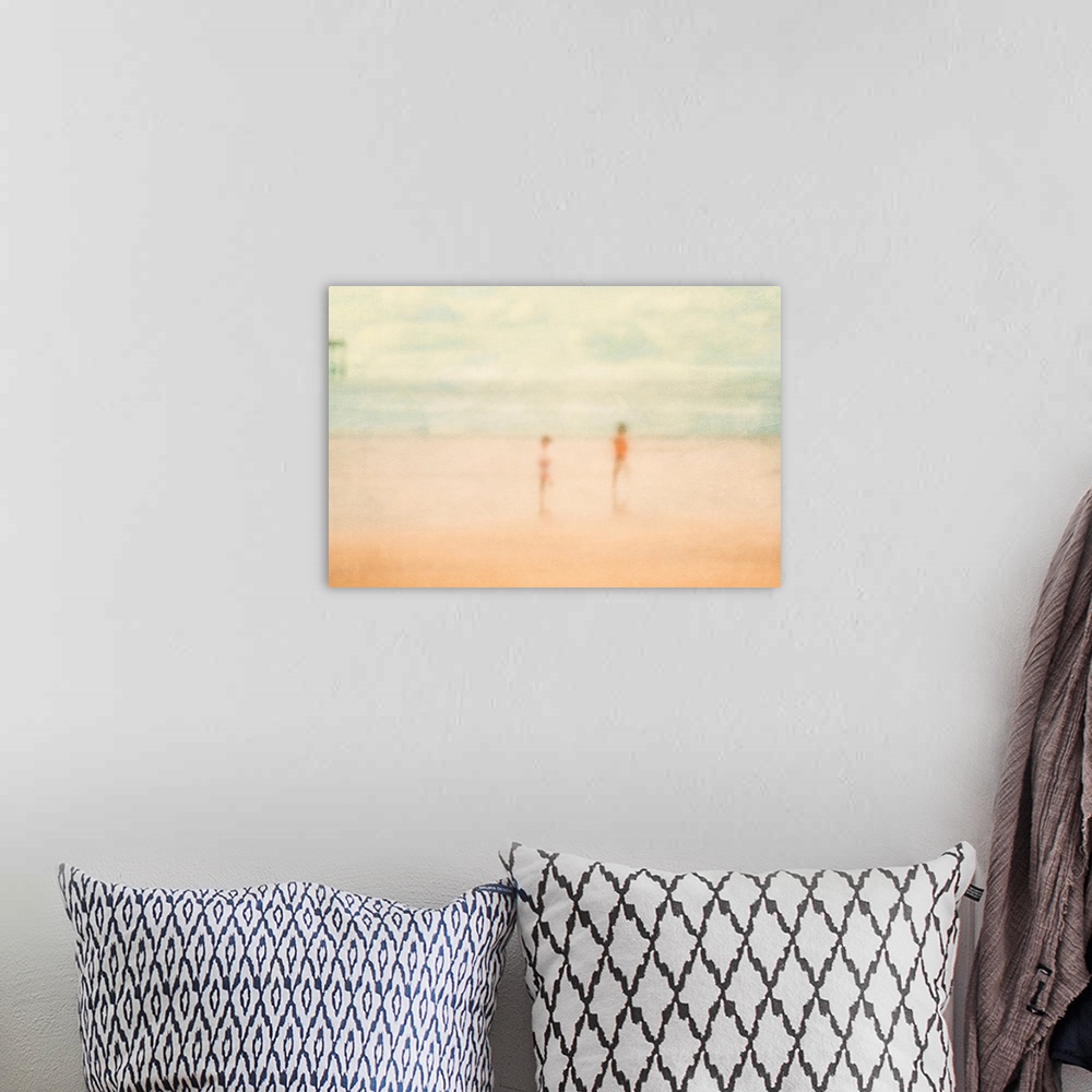 A bohemian room featuring Soft focus painting of two children standing on the beach with ocean and pier in distance.