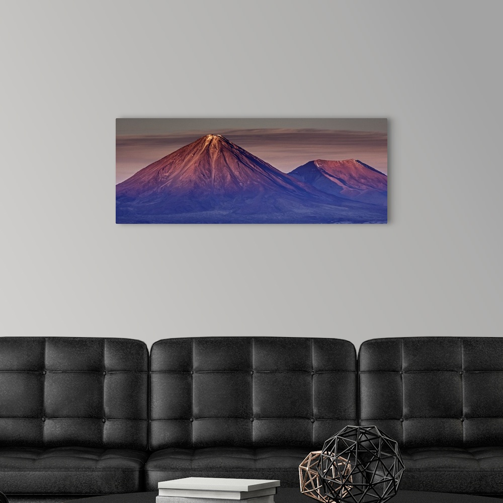 A modern room featuring Reddish alpenglow on the peaks of the Andes mountains in Chile.