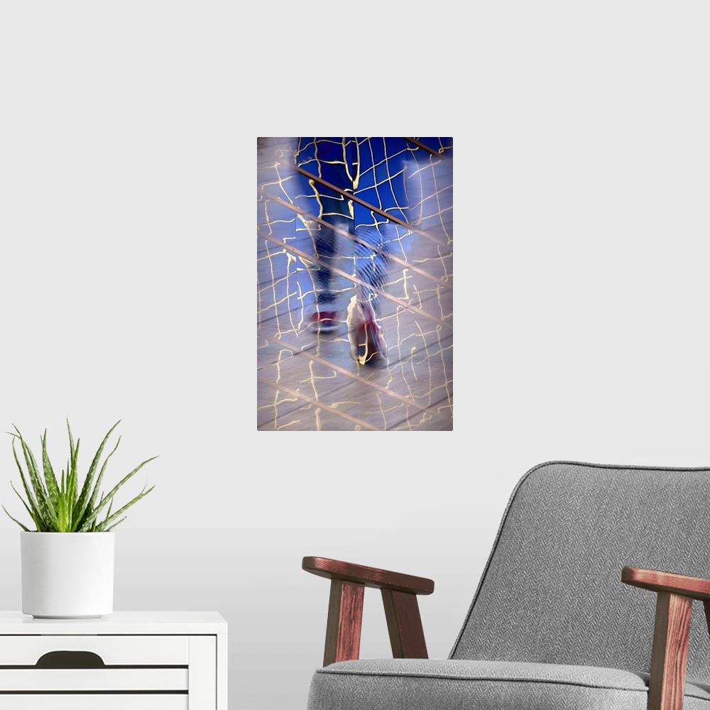 A modern room featuring Abstract image created by a reflection of a person walking in building windows.