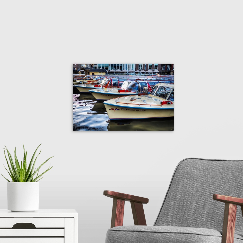 A modern room featuring Classic motorboats lined up in a pier, Amsterdam Netherlands.