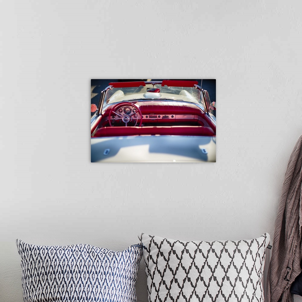 A bohemian room featuring A photograph of a vintage convertible.