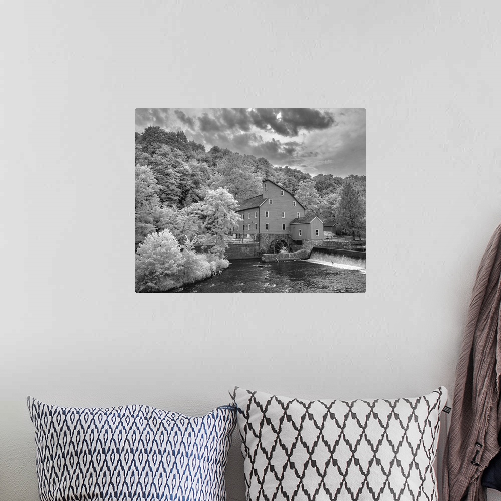 A bohemian room featuring In this black and white infrared light photograph, dramatic and brightly lit clouds rest over a b...