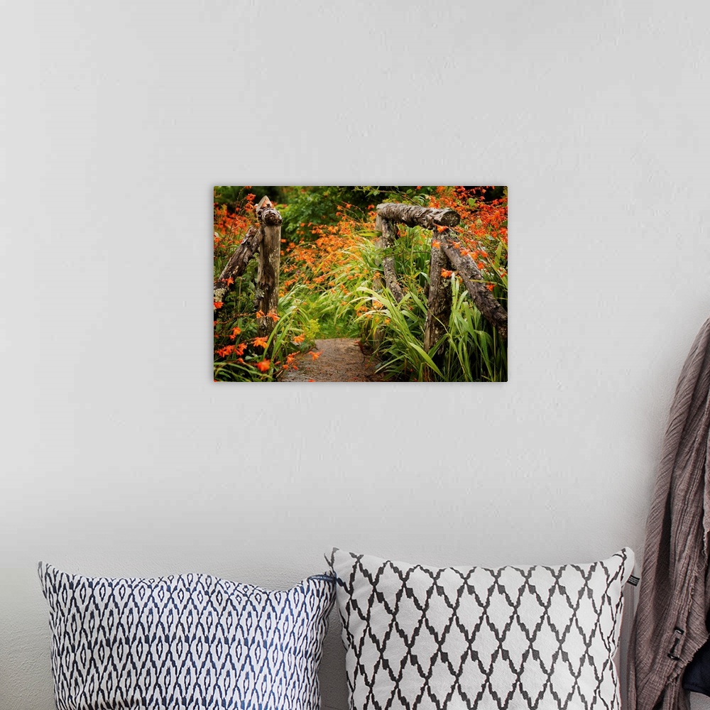 A bohemian room featuring Fine art photo of a garden path with bright flowers and a wooden gate.