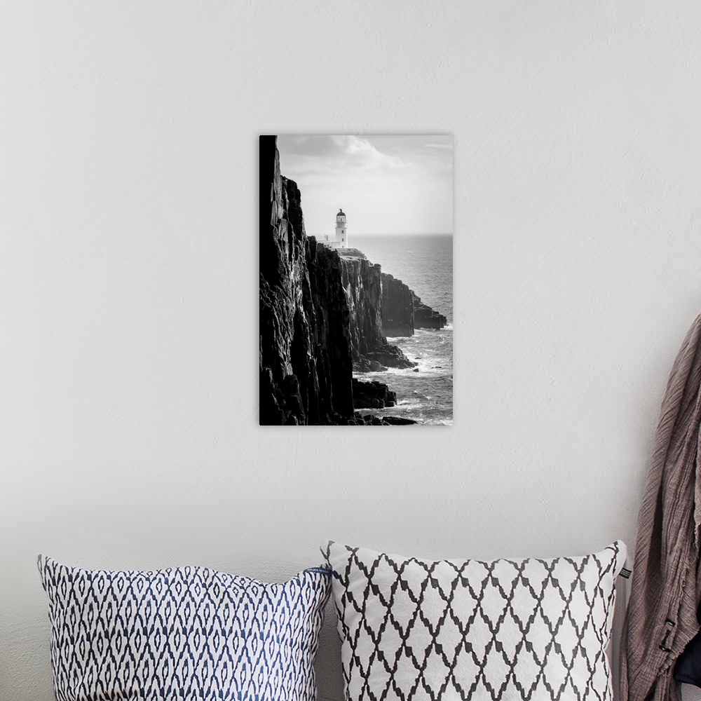 A bohemian room featuring Fine art photo of a lighthouse at the edge of a cliff by the ocean in black and white.