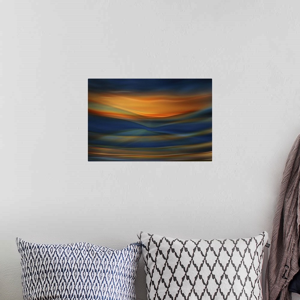 A bohemian room featuring Abstract photograph of blurred and blended colors and flowing lines in shades of orange and blue.
