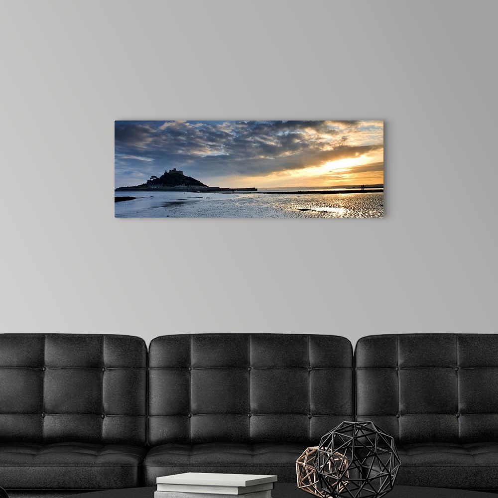A modern room featuring St. Michaels Mount, Cornwall, England, UK, at sunset with a dramatic sky and golden light reflect...