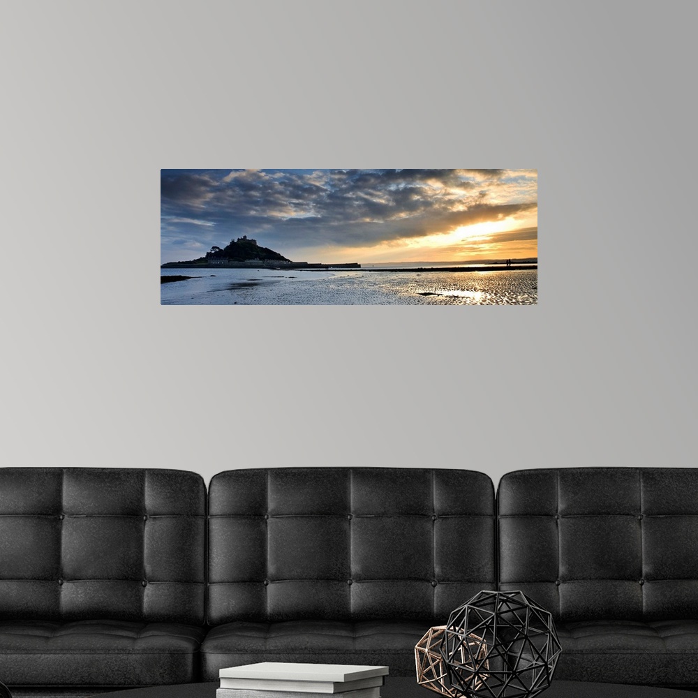 A modern room featuring St. Michaels Mount, Cornwall, England, UK, at sunset with a dramatic sky and golden light reflect...