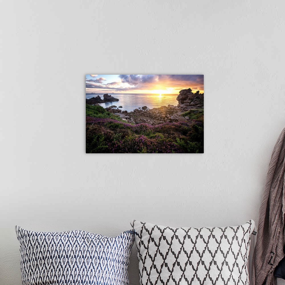 A bohemian room featuring Sunrise over the ocean seen from the rocky French coast.