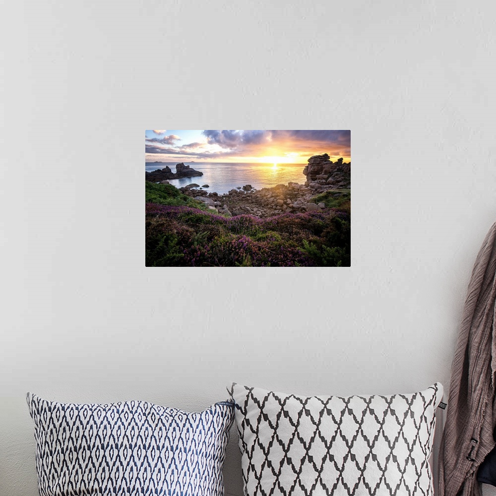 A bohemian room featuring Sunrise over the ocean seen from the rocky French coast.