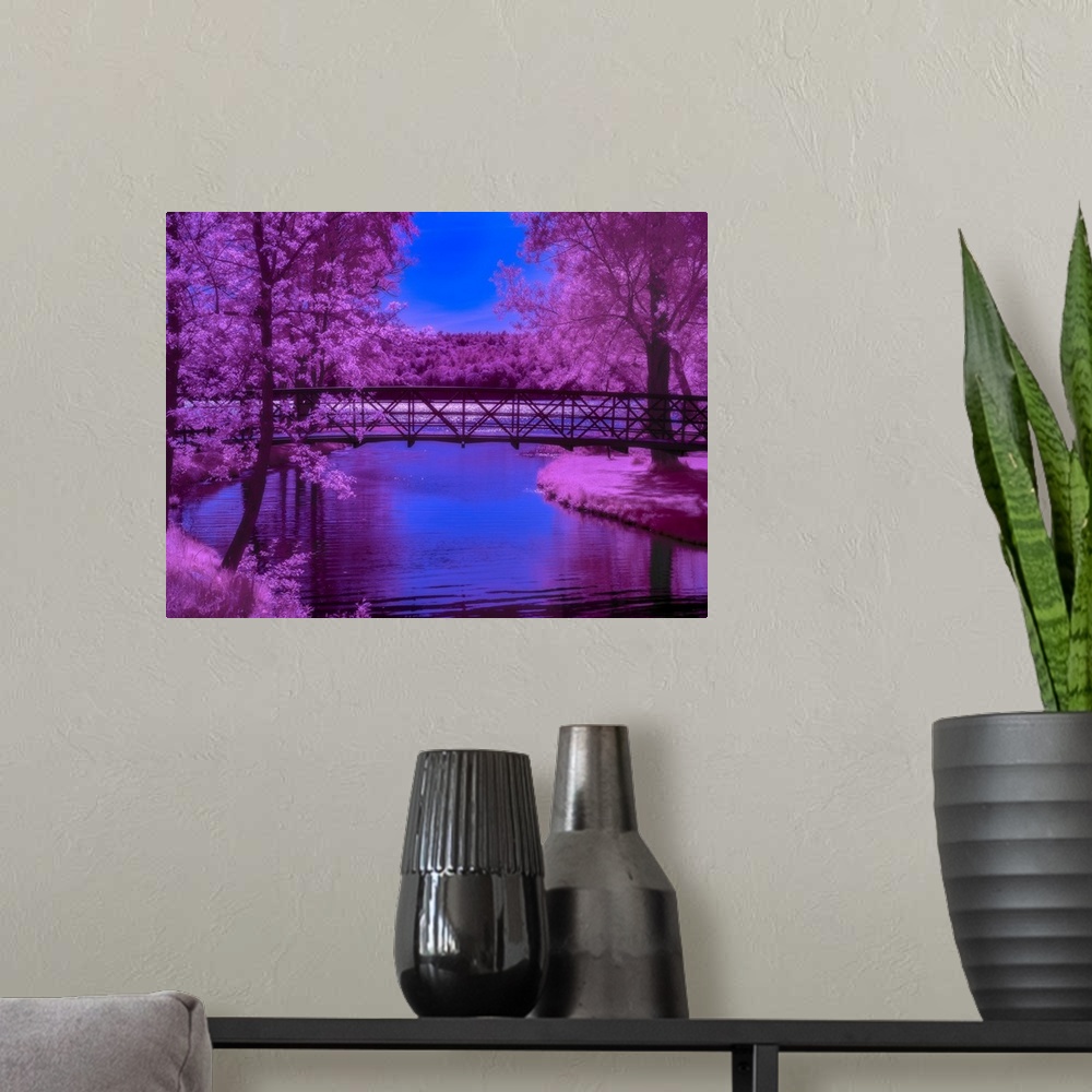 A modern room featuring Surreal photograph of a long bridge over a river lined with bright purple trees.
