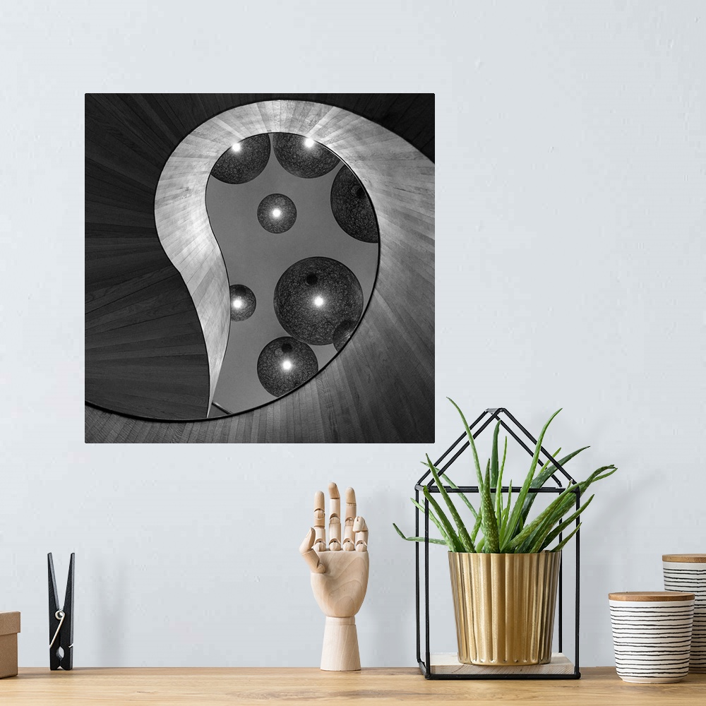 A bohemian room featuring Black and white abstract photograph of large and small spheres hovering around an organic archite...