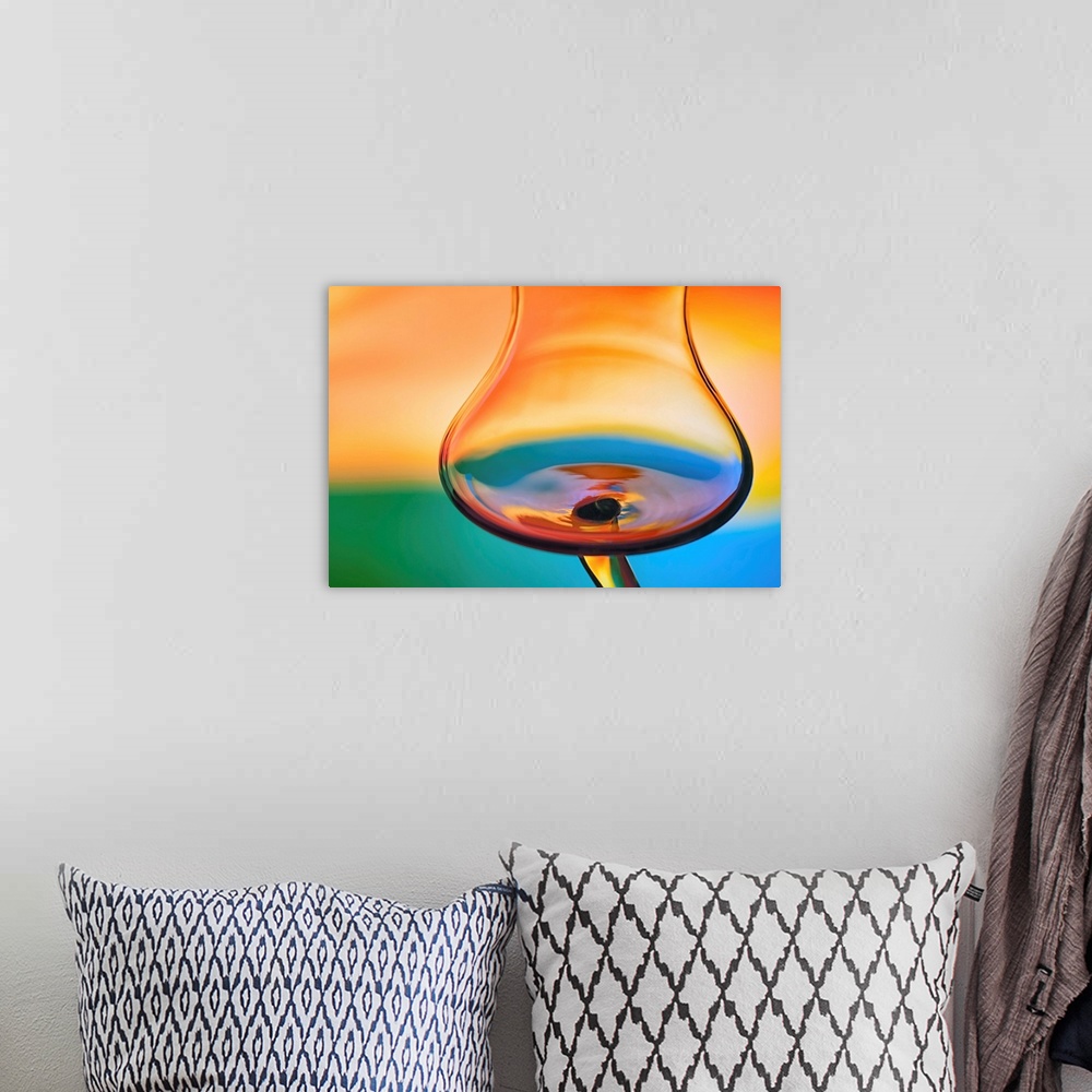 A bohemian room featuring Abstract photo of a wine glass reflecting warped colors.