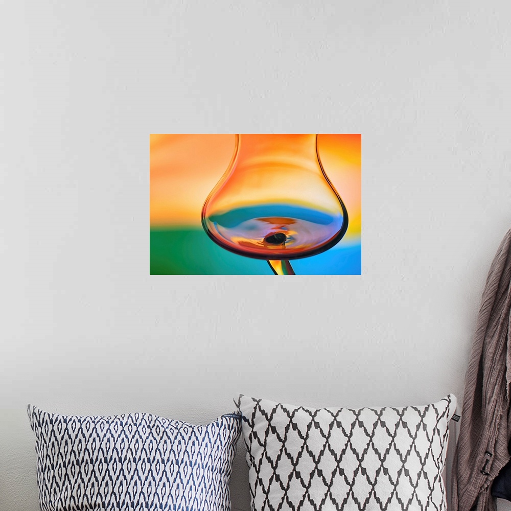 A bohemian room featuring Abstract photo of a wine glass reflecting warped colors.