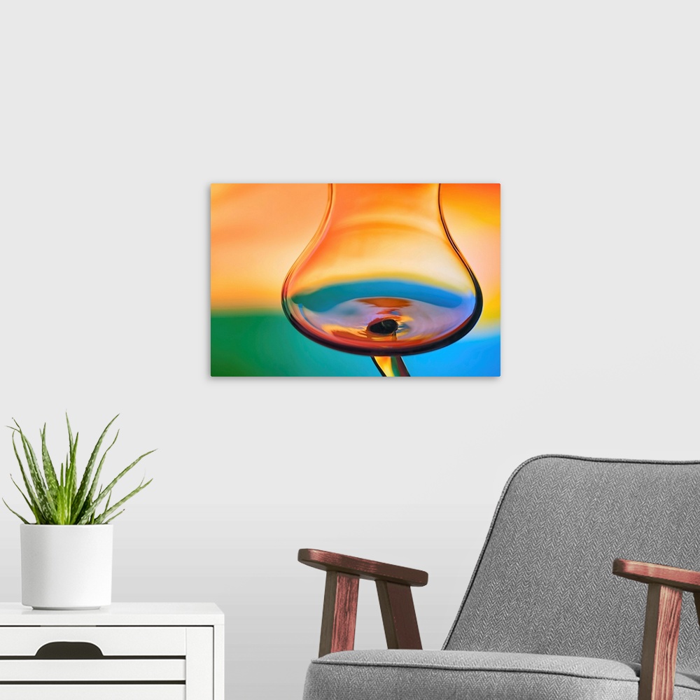 A modern room featuring Abstract photo of a wine glass reflecting warped colors.