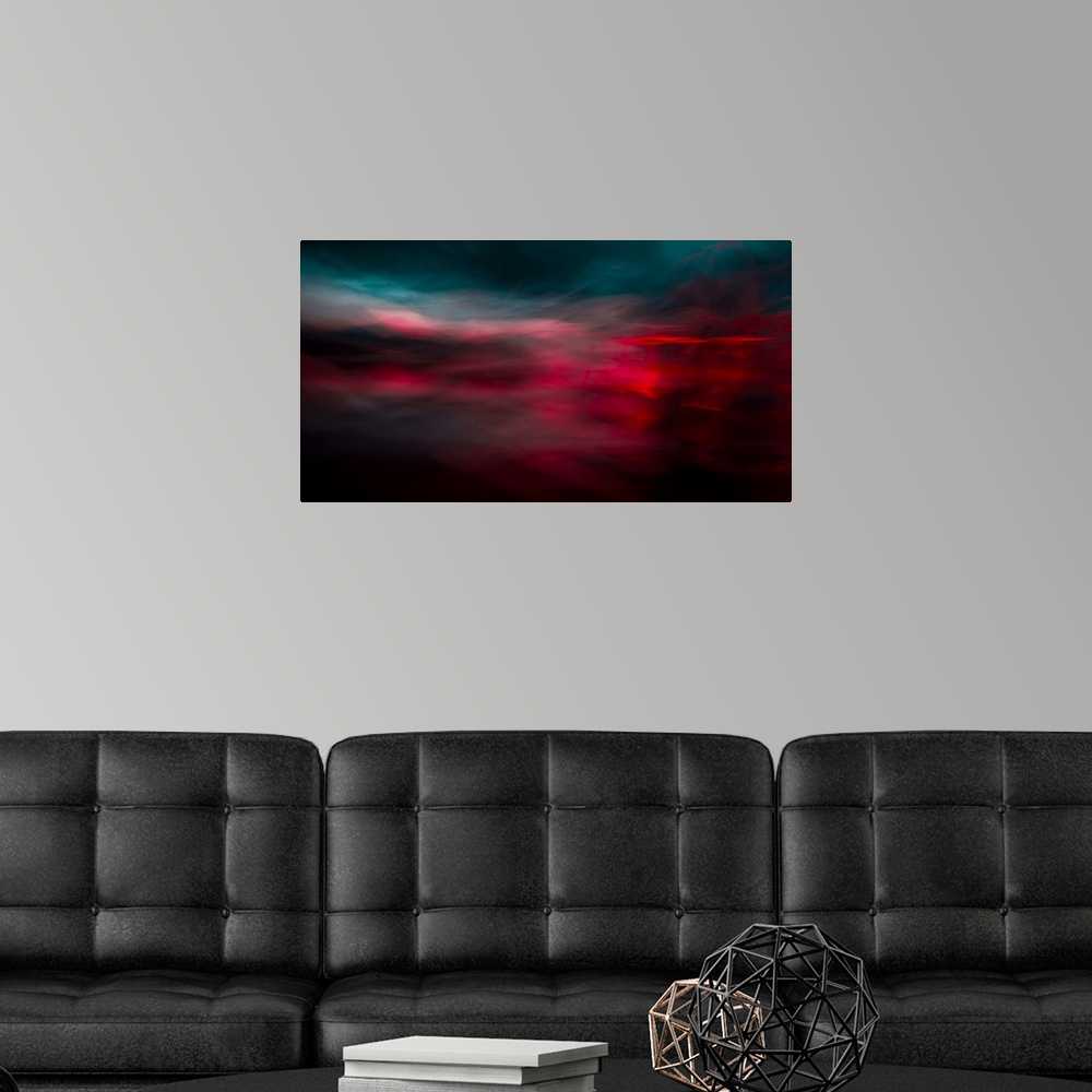 A modern room featuring An impressionistic dreamy blurred Turneresque seascape of swirling water and sky in dramatic deep...
