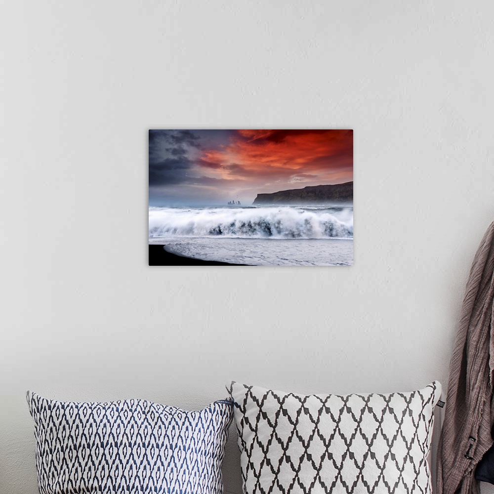 A bohemian room featuring Photograph of a large crashing wave onto the shore with a bold red sunset above and a crescent mo...