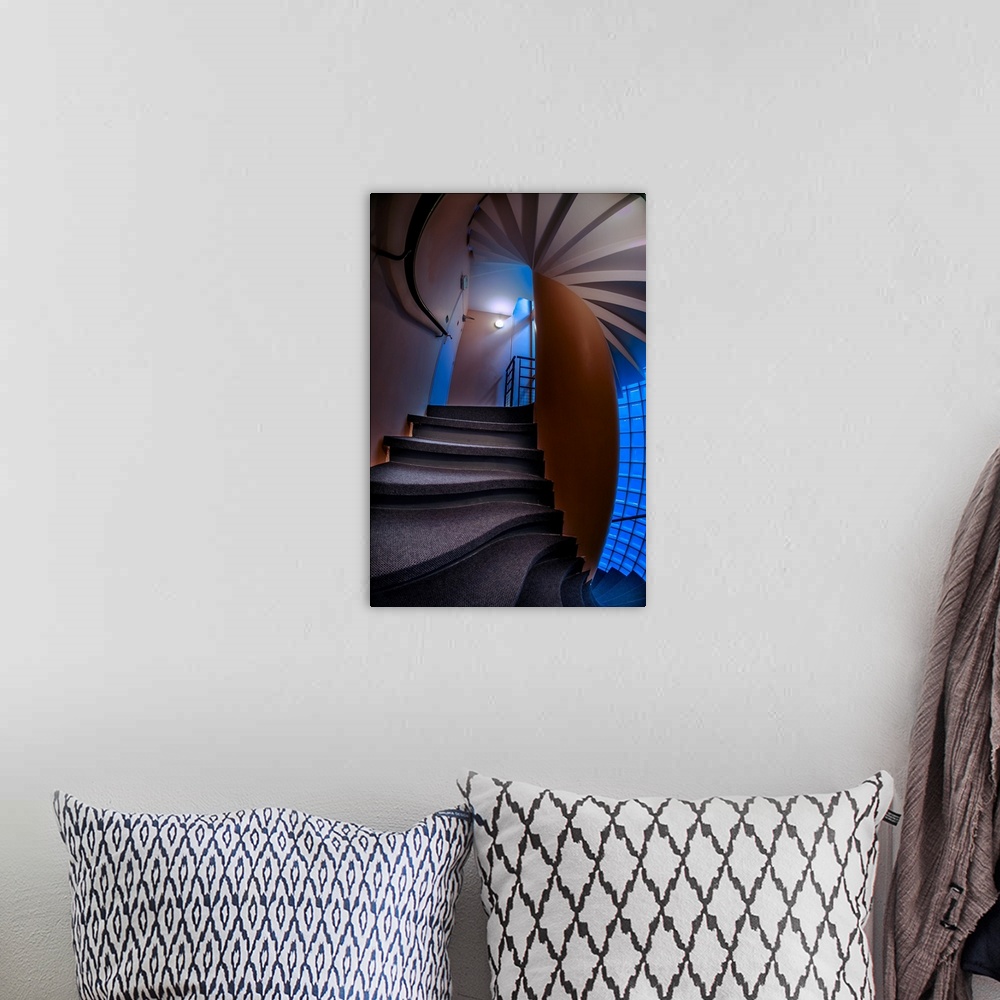 A bohemian room featuring Warped, twisted steps and walls in a stairwell with blue light.