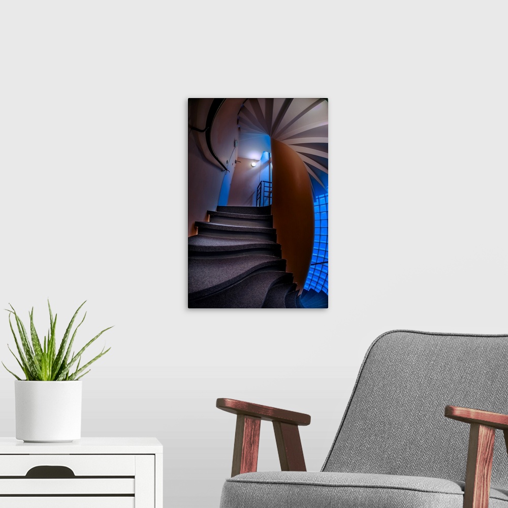 A modern room featuring Warped, twisted steps and walls in a stairwell with blue light.