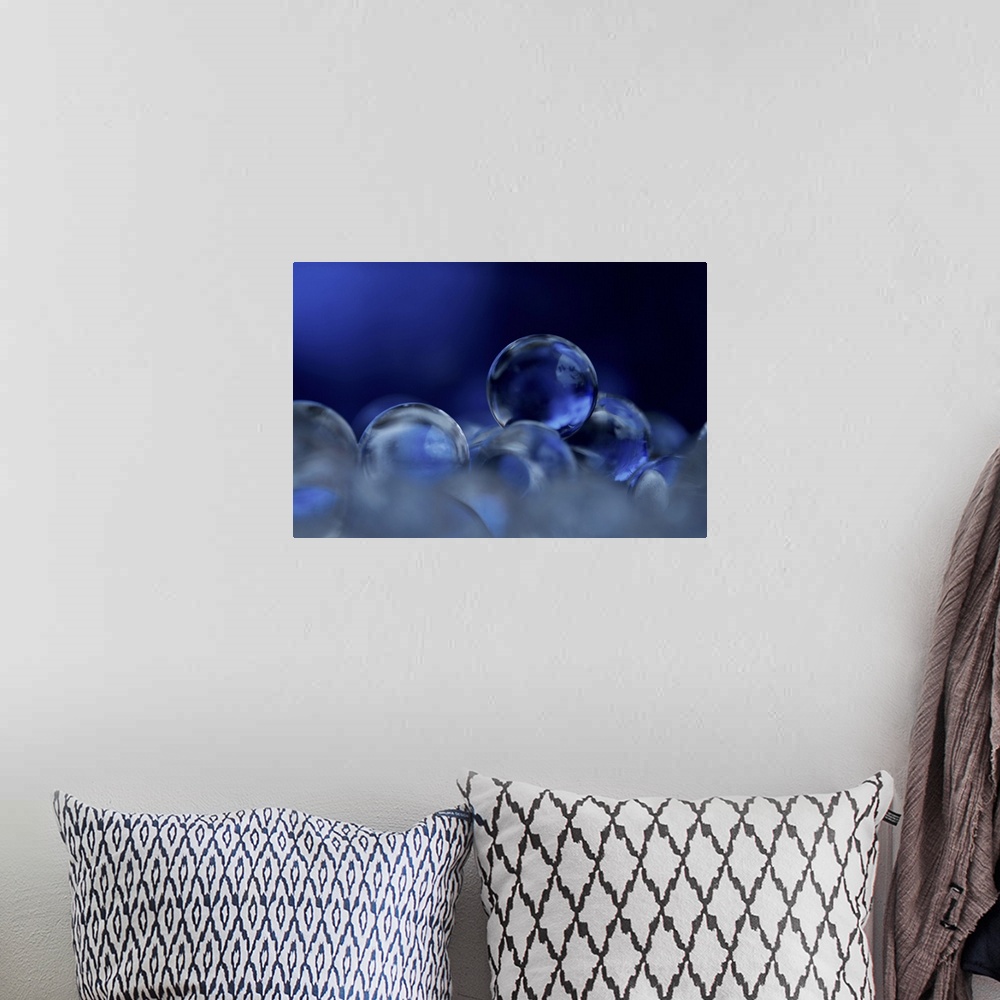 A bohemian room featuring A macro photograph of a stack of blue clear spheres.