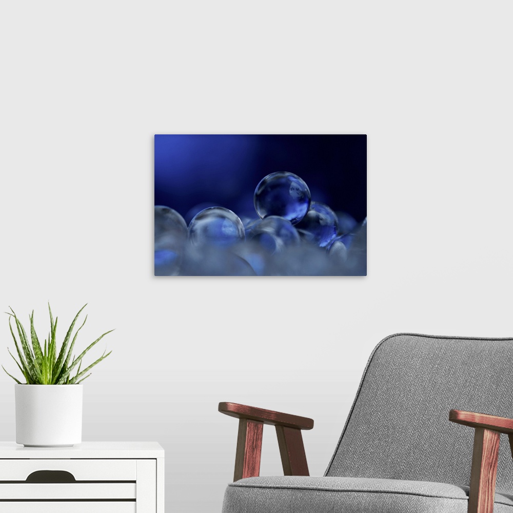 A modern room featuring A macro photograph of a stack of blue clear spheres.