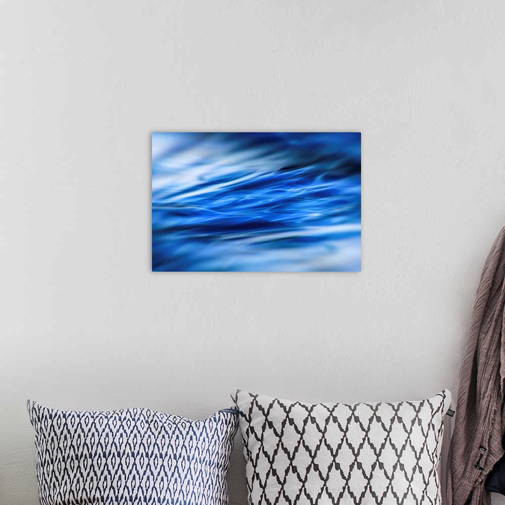 A bohemian room featuring Abstract photograph of moving blue water with white highlights and a blurred vignette.