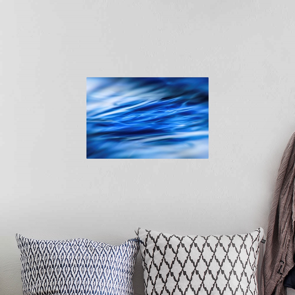 A bohemian room featuring Abstract photograph of moving blue water with white highlights and a blurred vignette.