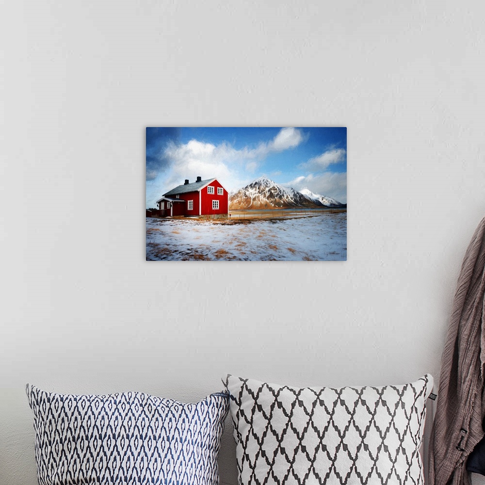 A bohemian room featuring A photograph of a mountain landscape with a red house in the foreground of the image.