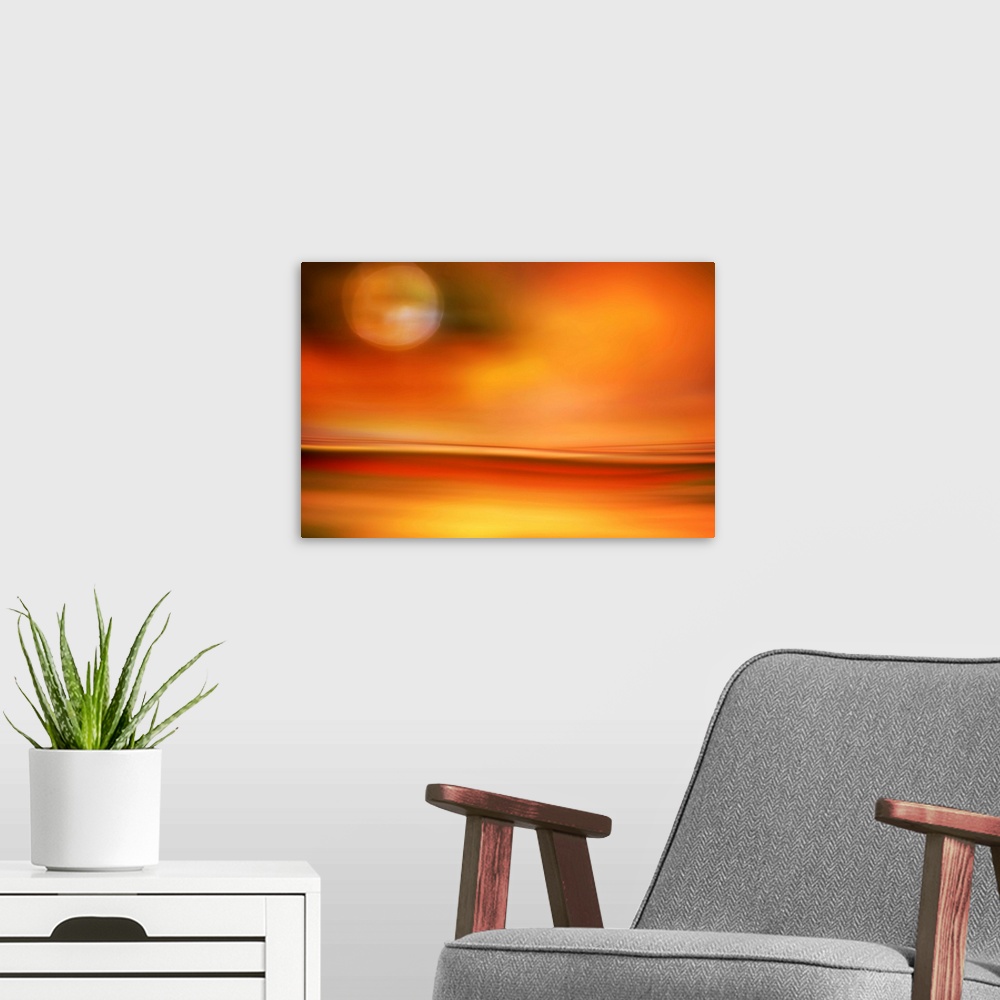 A modern room featuring Abstract photo of smooth waves in bright orange tones resembling the moon in the sky over a desert.