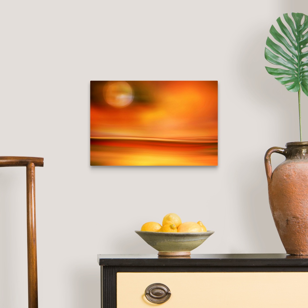 A traditional room featuring Abstract photo of smooth waves in bright orange tones resembling the moon in the sky over a desert.