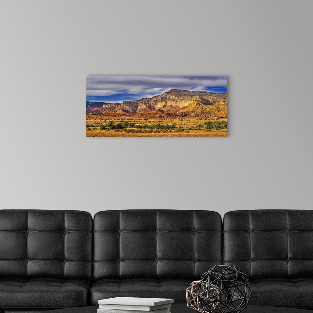 A modern room featuring A myriad display of mountainous desert rock formations featuring rusty reds, yellows, browns, gra...