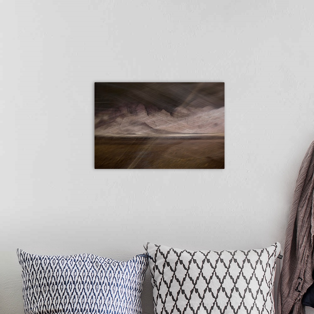 A bohemian room featuring Abstract image of a desert storm with thin lines on top creating movement and a rocky textured ba...