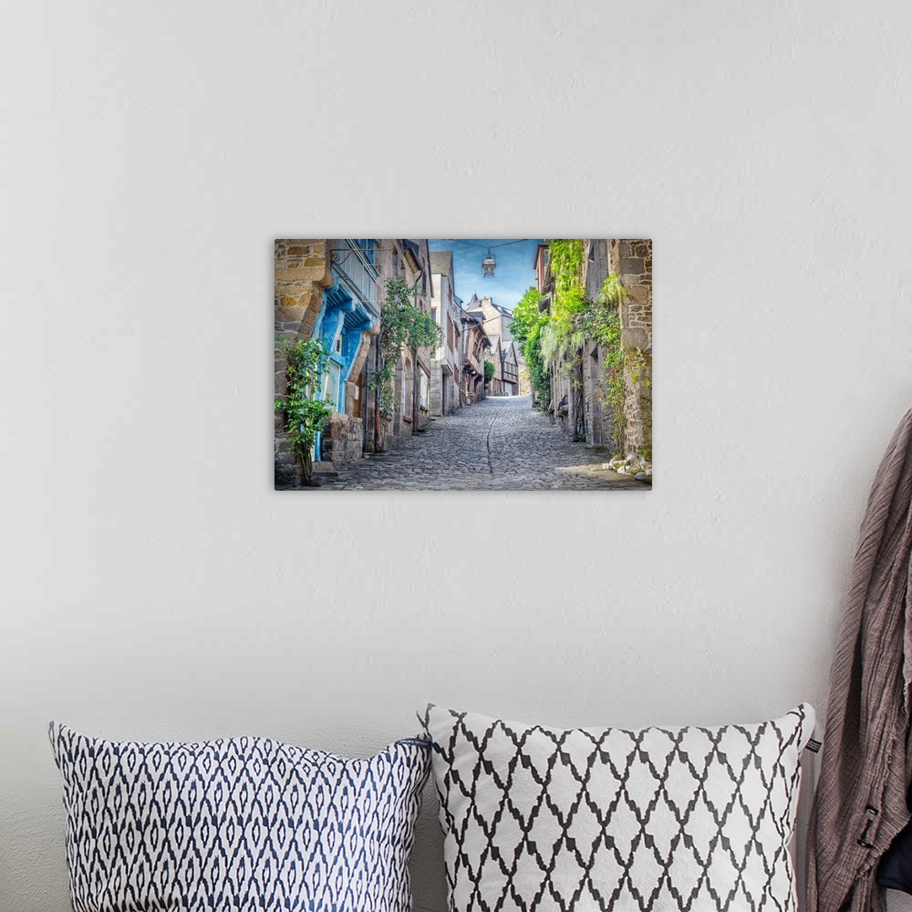 A bohemian room featuring A photograph of a French village.