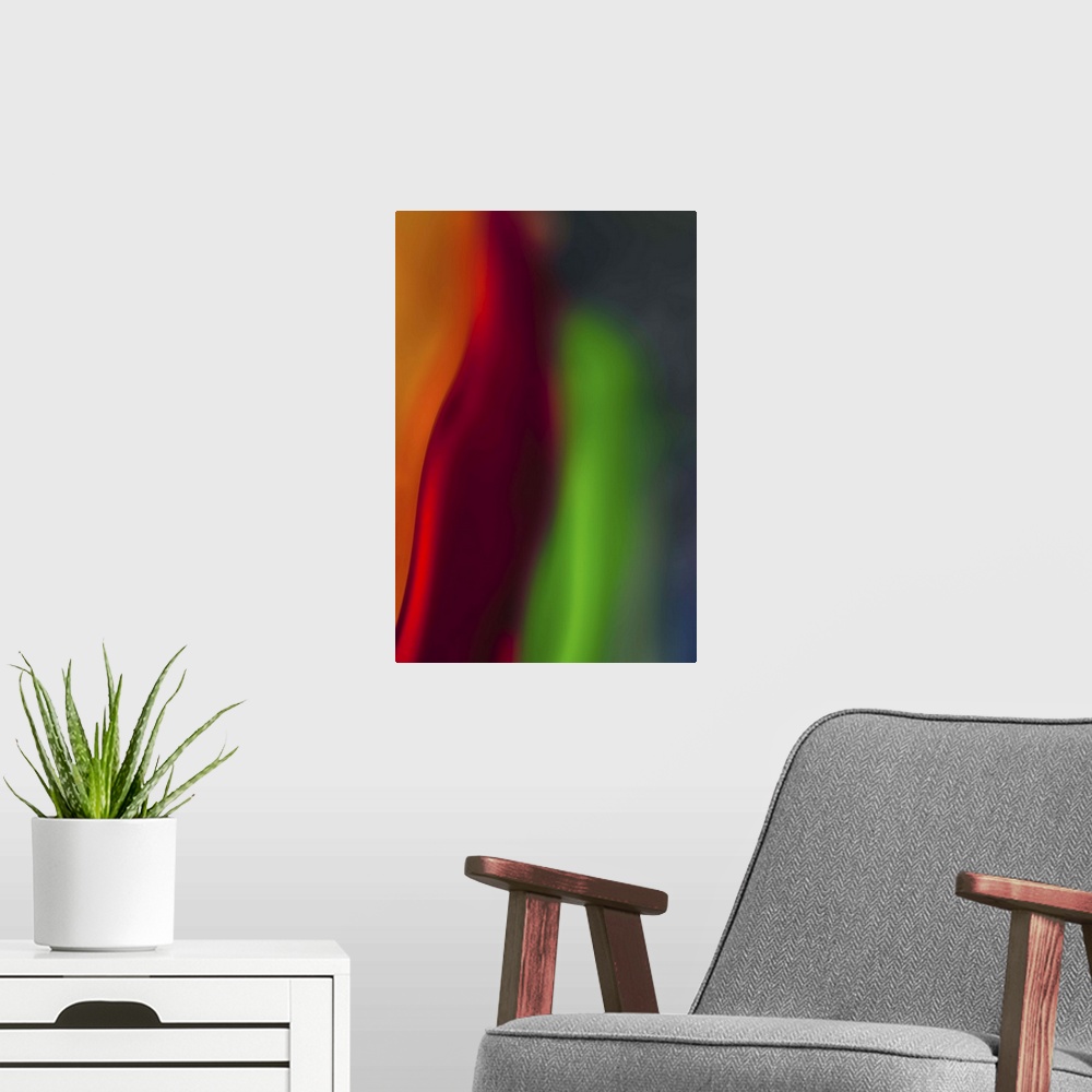 A modern room featuring Abstract photograph in green and red vertical layers.