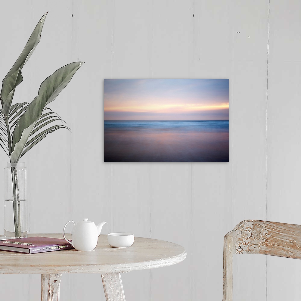 A farmhouse room featuring An abstract fine art photograph of a sunrise that has a soft and blurred appearance.