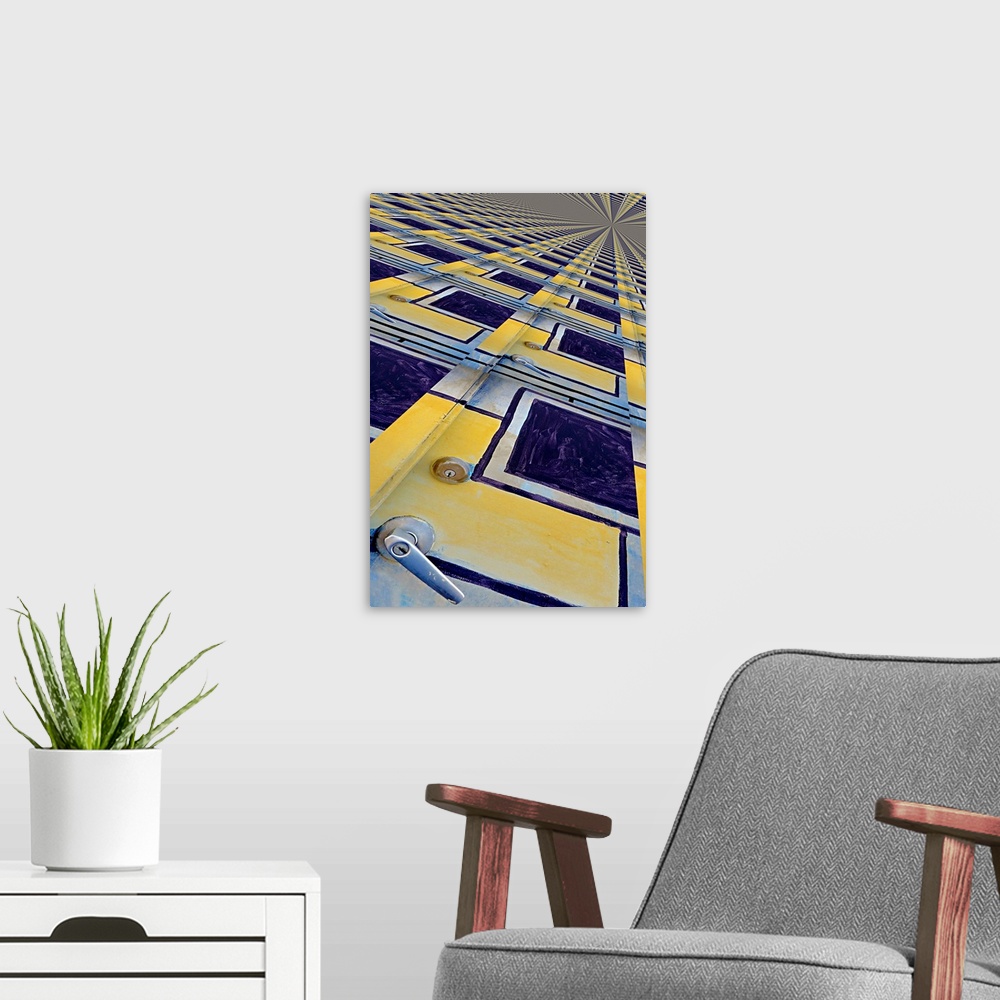 A modern room featuring Image of a yellow and blue painted door repeated several times into a pattern, creating an abstra...