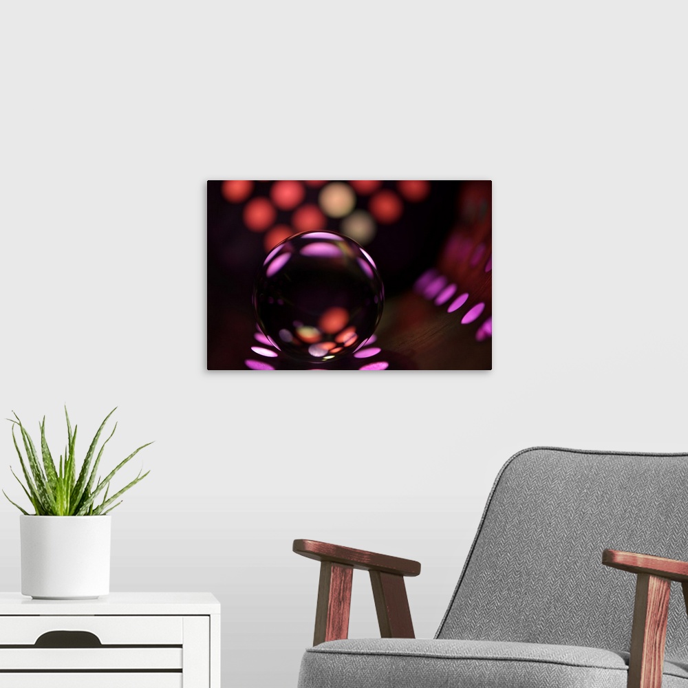 A modern room featuring Abstract photo of a glass ball reflecting colored dots.