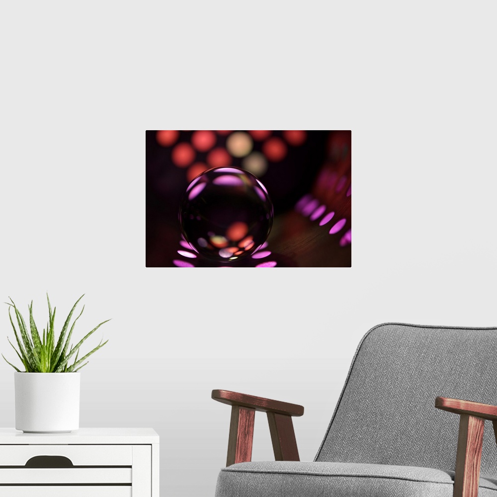 A modern room featuring Abstract photo of a glass ball reflecting colored dots.