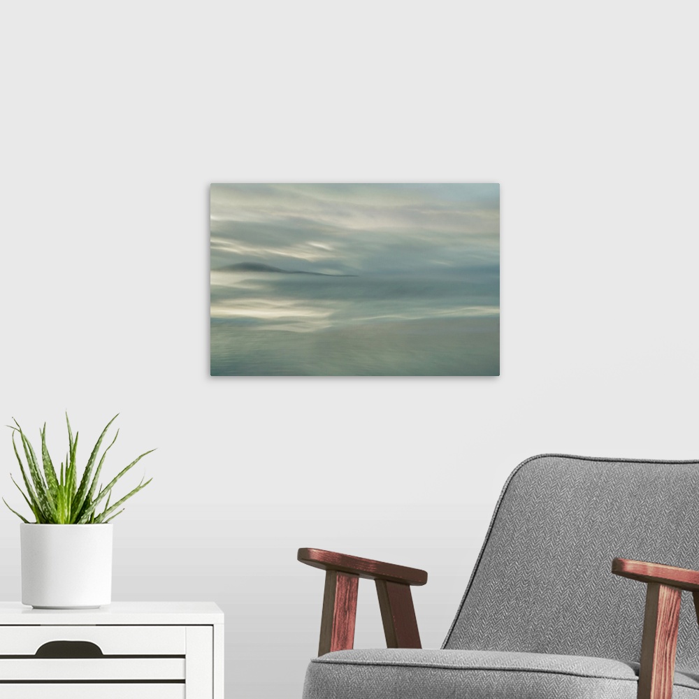 A modern room featuring Abstract fine art photograph of a dreamy ocean and a darker silhouetted island in the distance.