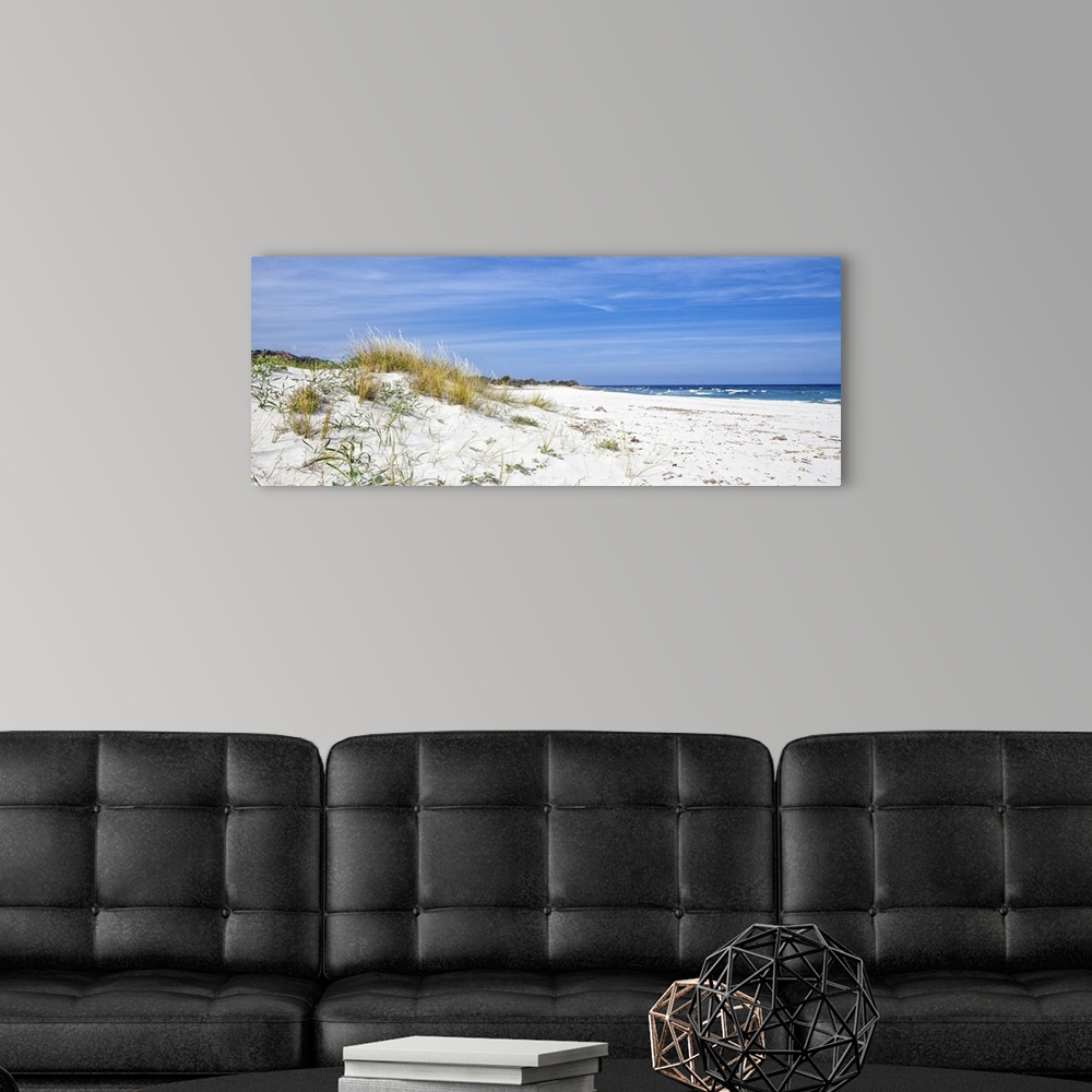 A modern room featuring This picture was shot in Sardinia in the summer. A lonely beach with dunes and shrubs with the se...