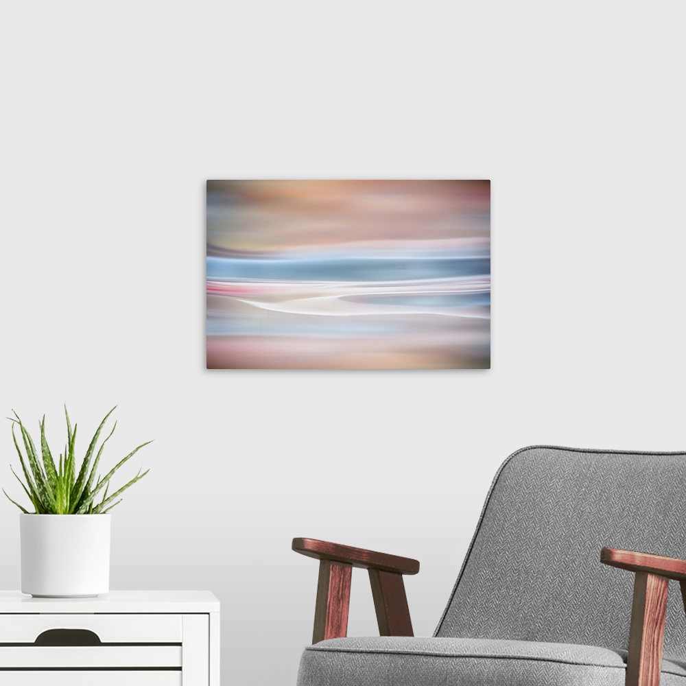A modern room featuring Abstract artwork of warm and cool colors to create an ethereal mood.