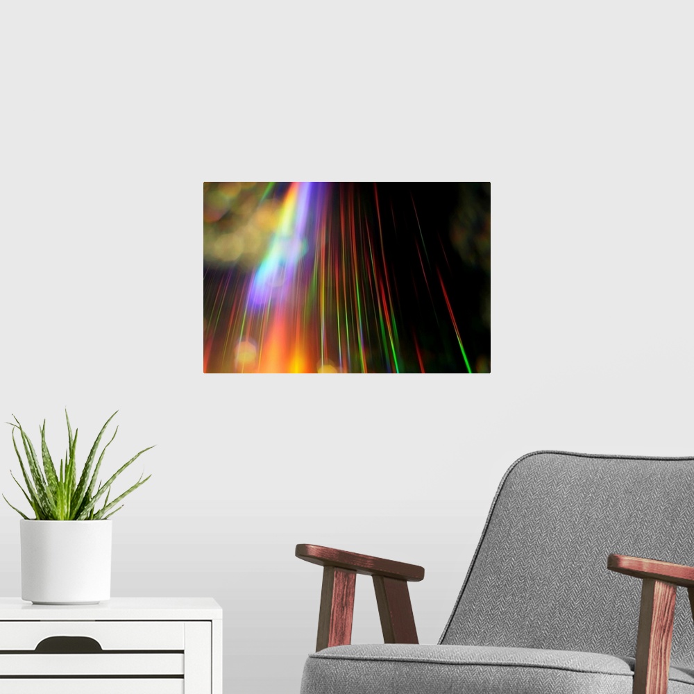 A modern room featuring An abstract piece with a rainbow of colors streaking vertically on the print against a black back...