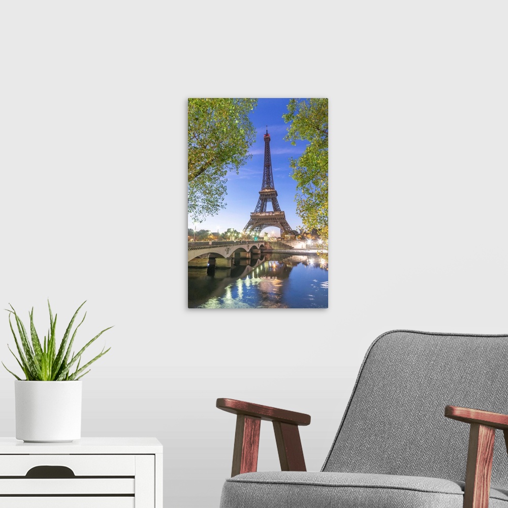 A modern room featuring Early morning for the Eiffel tower in Paris, facing the Jena bridge with green trees around and l...