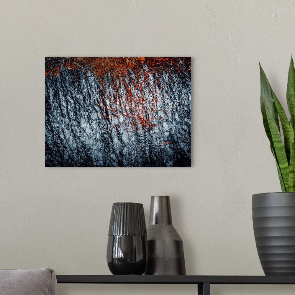 A modern room featuring Abstract photograph with rough textures in black, red, and white.