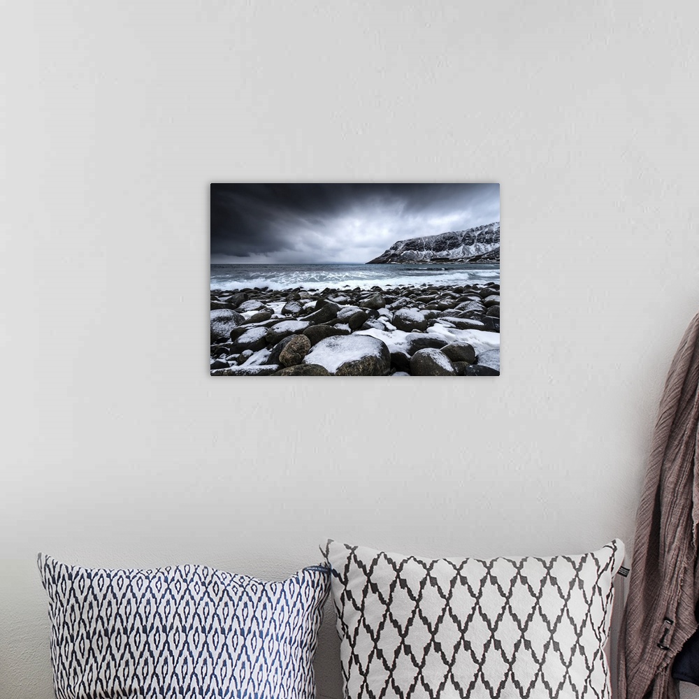 A bohemian room featuring A photograph of snow covered mountains seen from the shore of a lake.