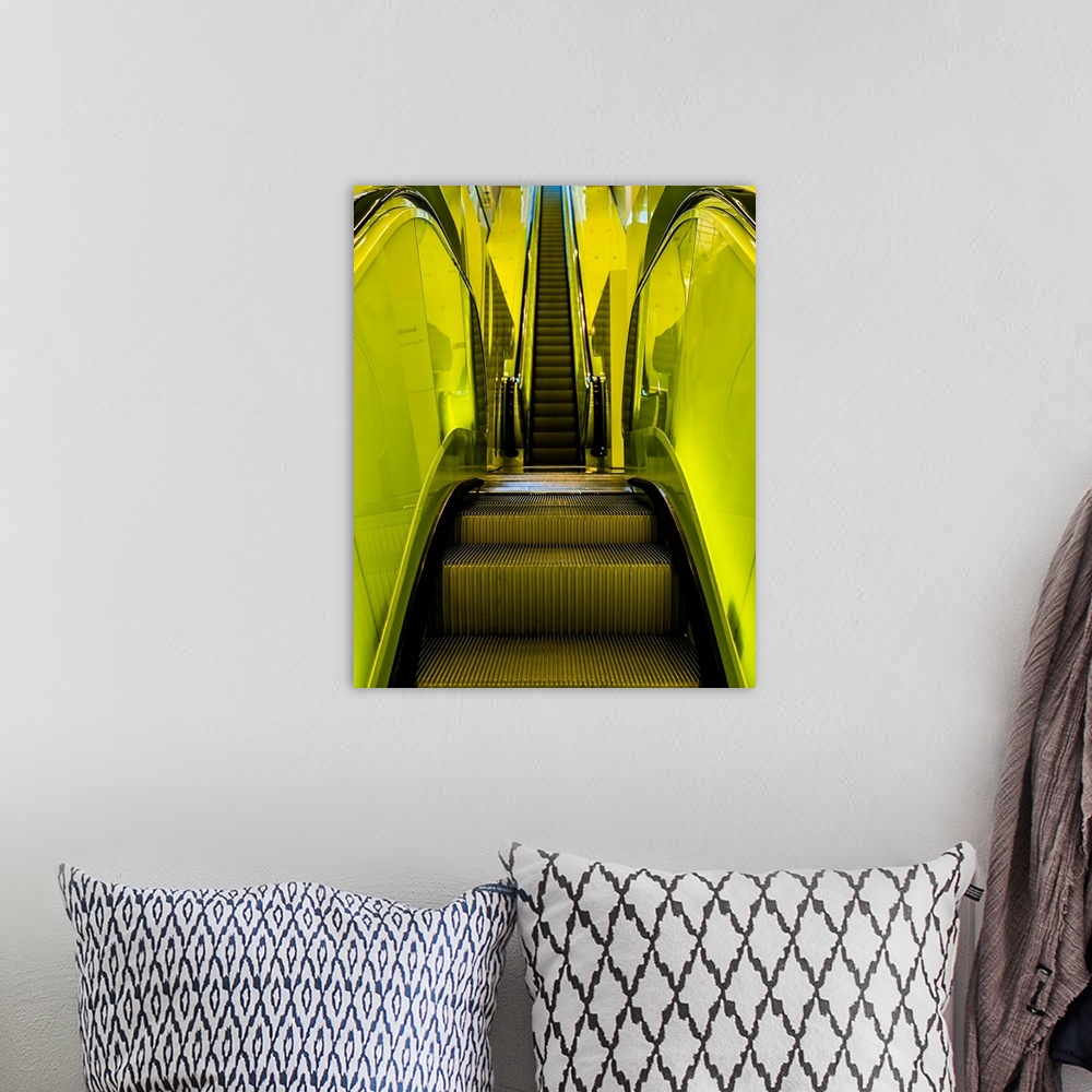 A bohemian room featuring Abstract view of escalator steps with lime green paneling.