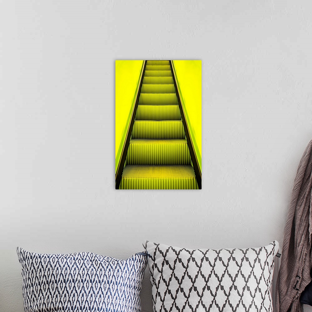 A bohemian room featuring Bright yellow light on escalator steps leading upwards.