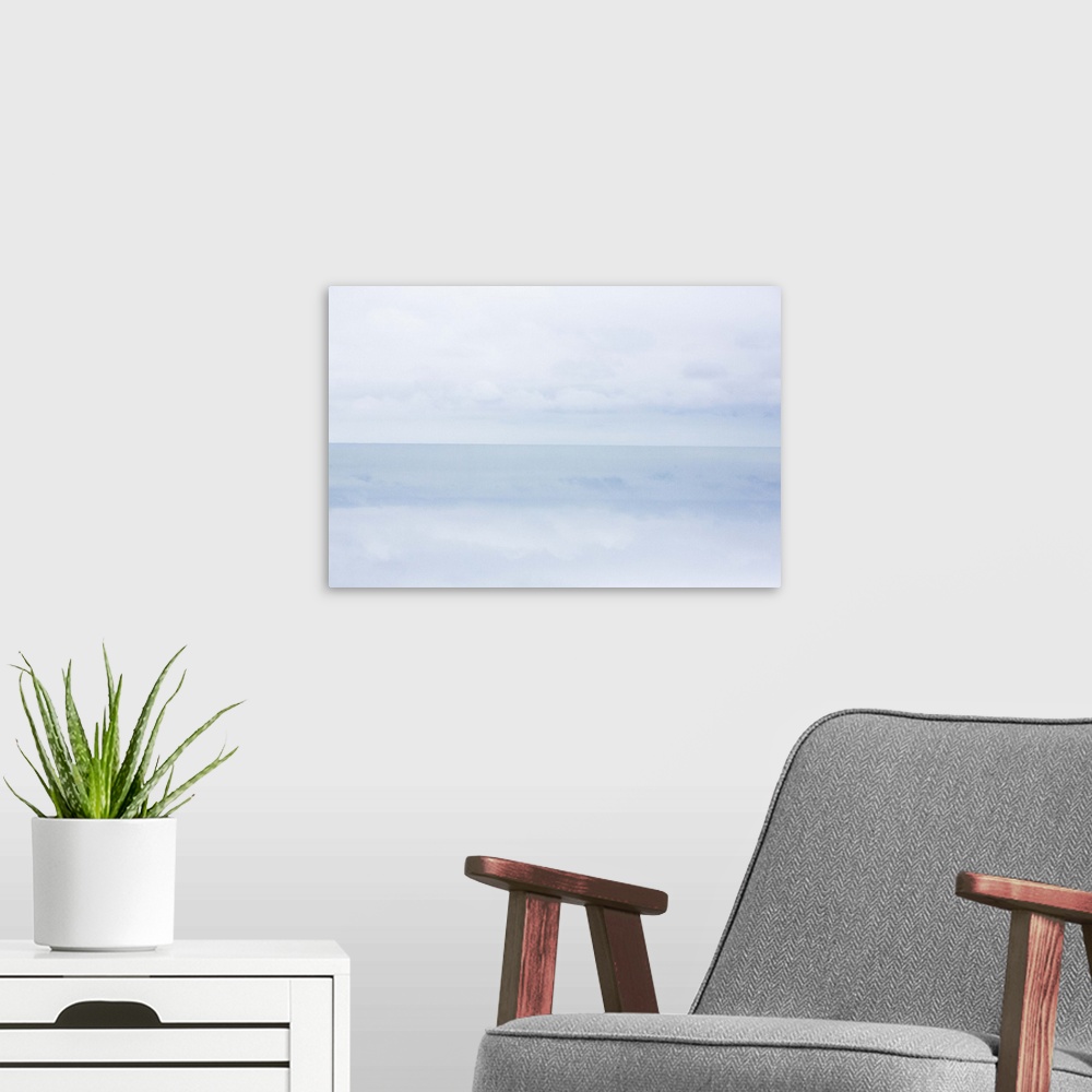 A modern room featuring A photograph of a cold and frigid seascape.